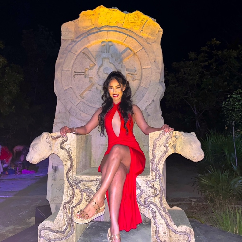 Small Red Asymmetrical dress with multiple way top and slit on the side.